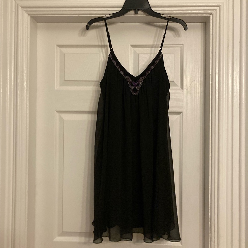 Small spaghetti strap, flowy dress with beading at the neckline.
